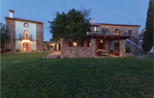 a large house with a staircase leading up to it at Lovely Home In Gracisce in Gračišče