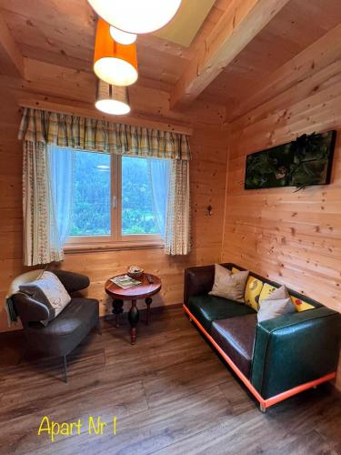 a living room with a couch and a table at Alpenburg Bergparadies Apartments in Wald am Arlberg