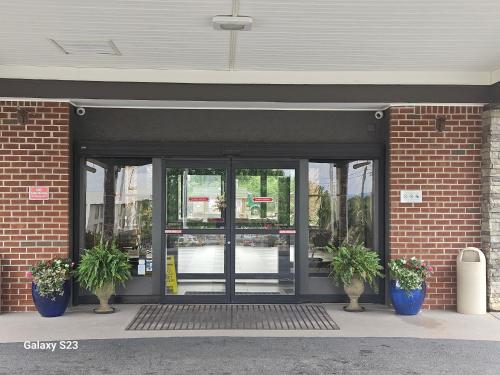 an entrance to a building with two potted plants in front at Quality Inn Dublin I-81 in Dublin
