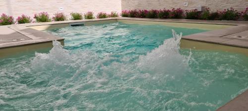 a water fountain in a swimming pool at La Dimora del Cuore in Mesagne