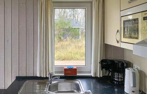 a kitchen with a sink and a window at Freibeuterweg 23 - Dorf 5 in Travemünde