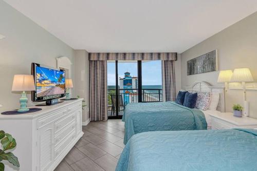 a hotel room with two beds and a television at Stunning Penthouse! Amazing Oceanview! Dogs OK 1902 in Myrtle Beach