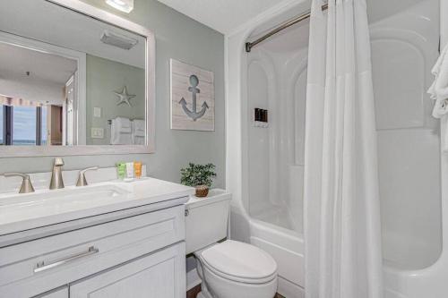 a white bathroom with a toilet and a sink at Stunning Penthouse! Amazing Oceanview! Dogs OK 1902 in Myrtle Beach