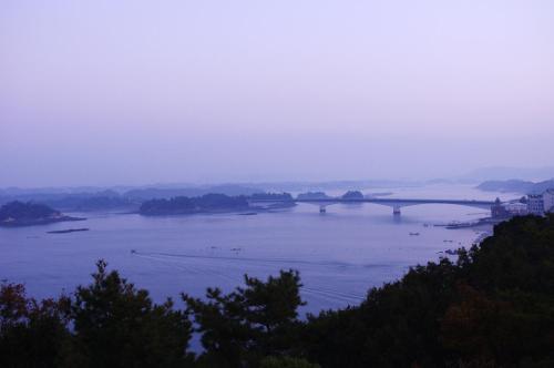 a large body of water with a bridge in the distance at Misakitei in Kami Amakusa