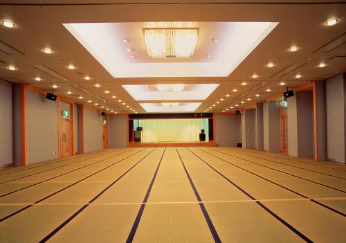 an empty dance floor in a hall with a stage at Misakitei in Kami Amakusa
