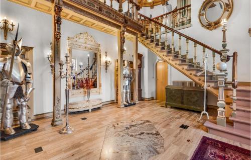 a large room with a staircase and a mirror at 11 Bedroom Cozy Home In Gørding in Gørding