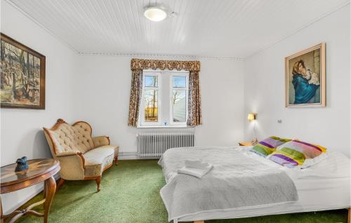 a bedroom with a bed and a table and a chair at 11 Bedroom Cozy Home In Gørding in Gørding