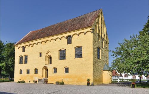 a large yellow building with a brown roof at 6 Bedroom Gorgeous Home In Tomelilla in Tomelilla