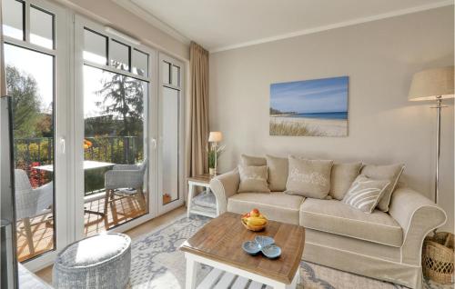 a living room with a couch and a table at Baltischer Hof Apartment 26 in Boltenhagen