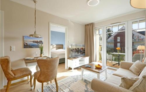 a living room with a couch and a table at Baltischer Hof Apartment 26 in Boltenhagen