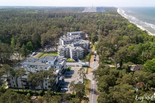 an aerial view of a large building next to the beach at Grunwaldzka 12 B22 - Easy-Rent Apartments - 50m od plaży in Pobierowo