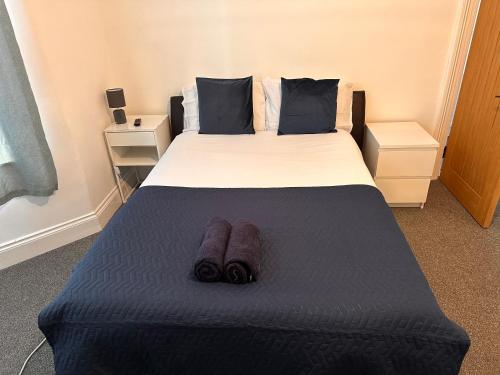 a bedroom with a large bed with blue sheets and pillows at Perfect room 1 in Bristol