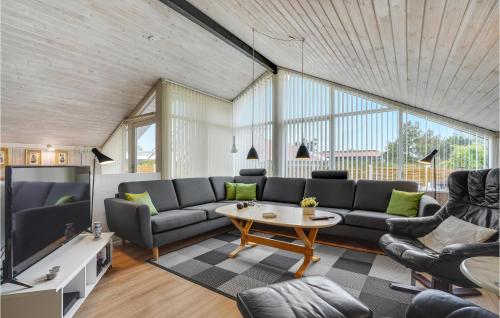 a living room with a couch and a table at Holiday Home Mosebøllevej Thisted Denm in Nørre Vorupør