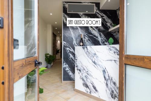 a hallway with a door with a sign that reads stir hugo room at San Giusto Rooms in Giardini Naxos