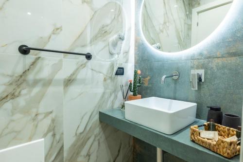a bathroom with a sink and a mirror at San Giusto Rooms in Giardini Naxos