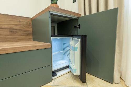 an open refrigerator with its door open in a kitchen at San Giusto Rooms in Giardini Naxos