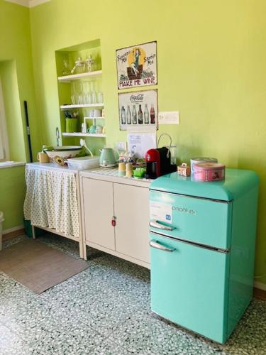 a kitchen with a blue refrigerator and a counter at La Vite è Bella in Govone