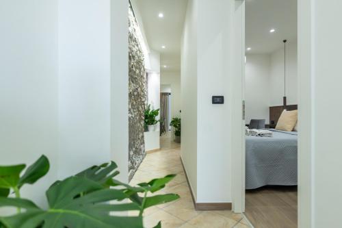 a hallway leading to a bedroom with a bed at San Giusto Rooms in Giardini Naxos