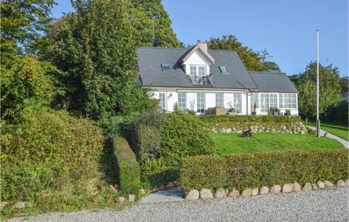a large white house with hedges in front of it at Three-Bedroom Holiday Home In Kolding in Kolding