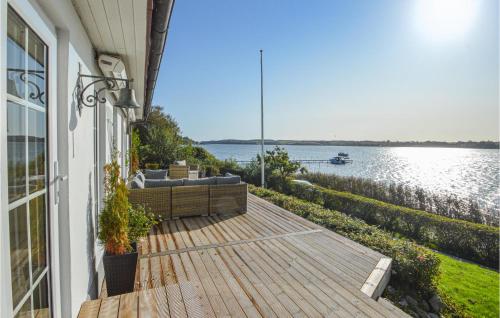 a house with a deck with a view of the water at Three-Bedroom Holiday Home In Kolding in Kolding