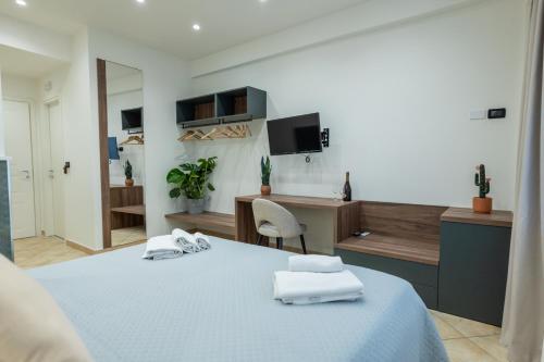 a bedroom with a bed with towels on it at San Giusto Rooms in Giardini Naxos
