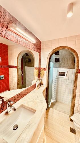 a bathroom with a sink and a mirror at Apostolis House in Mikonos