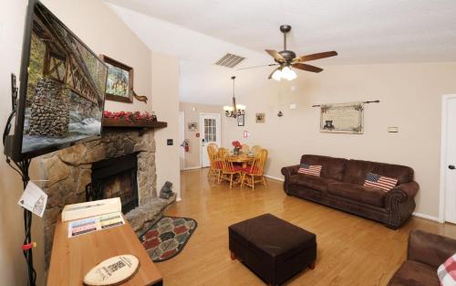 a living room with a couch and a fireplace at Serenity in Pigeon Forge