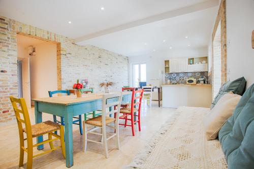 a kitchen and dining room with a blue table and chairs at La Terrazza sul Vigneto in Offida