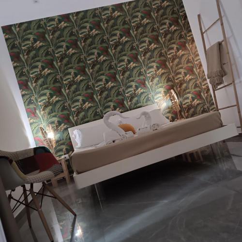 a room with a wall with a mural of plants at Bed Nonnonino in Porto Cesareo