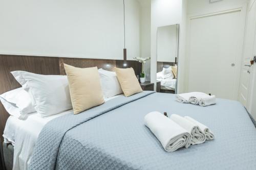 a bedroom with a bed with two towels on it at San Giusto Rooms in Giardini Naxos