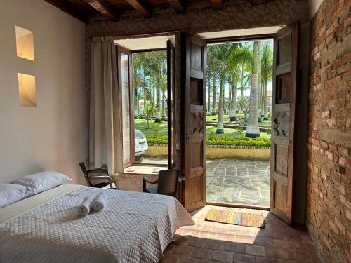 a bedroom with a bed and an open door at Casa Hotel Serena in Guadalupe