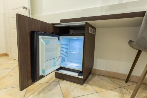 a refrigerator in a room with its door open at San Giusto Rooms in Giardini Naxos