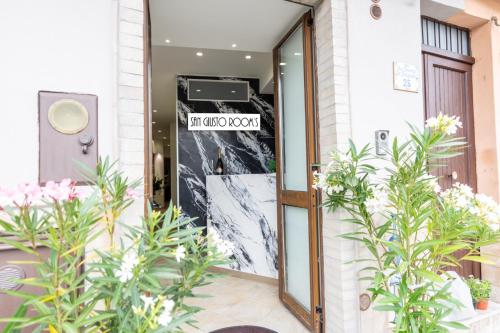an entrance to a hotel with a sign on the door at San Giusto Rooms in Giardini Naxos