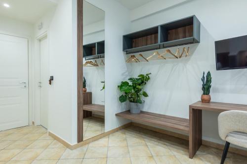 a hallway with a mirror and a table and a chair at San Giusto Rooms in Giardini Naxos