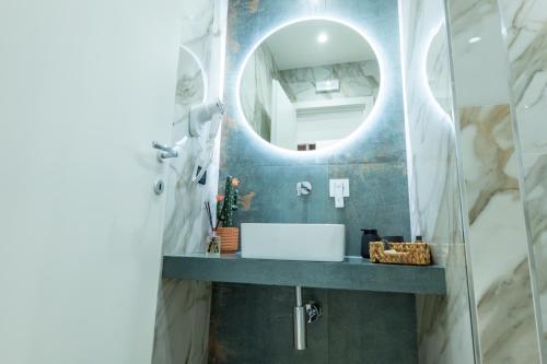 a bathroom with a sink and a mirror at San Giusto Rooms in Giardini Naxos