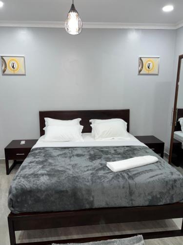 a bedroom with a large bed with white pillows at The wish executive lodge in Kafue