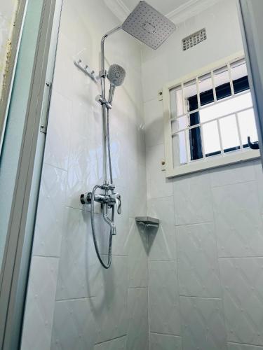 a shower in a bathroom with a glass door at The wish executive lodge in Kafue
