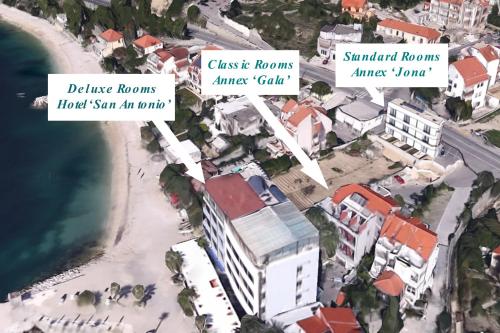 a map of a beach with buildings at Hotel San Antonio in Podstrana