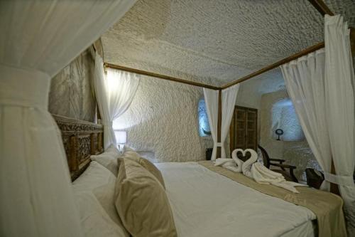 a bedroom with a bed with swans on it at Wish Cappadocia in Uchisar