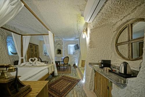 a bedroom with a bed and a table and a mirror at Wish Cappadocia in Uchisar