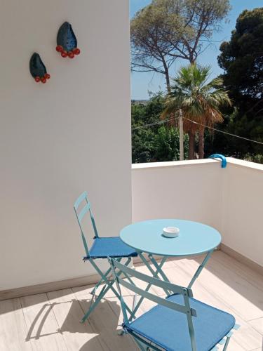 a blue table and a chair on a balcony at Alma in Matino