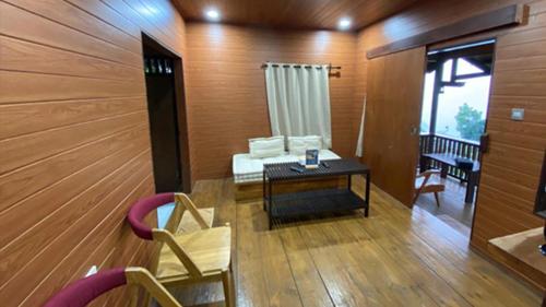 a living room with a couch and a table at Damar Langit Resort in Cisarua