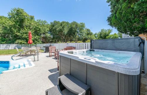 a large hot tub in a backyard with chairs at Family Tradition in Duck