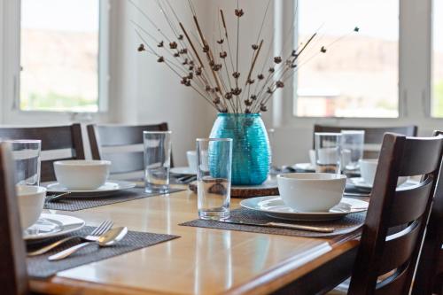 a table with a blue vase on top of it at 57 Robber's Roost in Moab