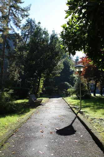 a shadow of a street light in a park at Bilocale Indipendente in Milan