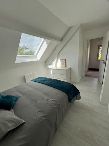 a bed in a white room with a window at Family Disney coconing à 10 minutes du Parc in Coupvray
