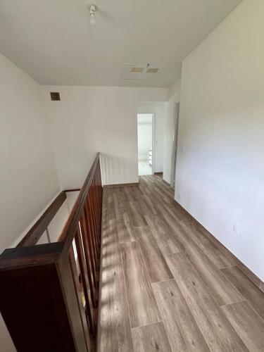 an empty room with a staircase and white walls at Family Disney coconing à 10 minutes du Parc in Coupvray
