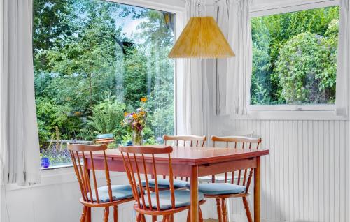 a dining room table with four chairs and a window at 2 Bedroom Gorgeous Home In Vig in Vig