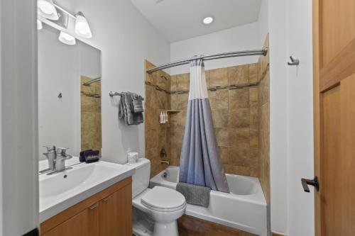 a bathroom with a sink and a toilet and a tub at 57 Robber's Roost in Moab