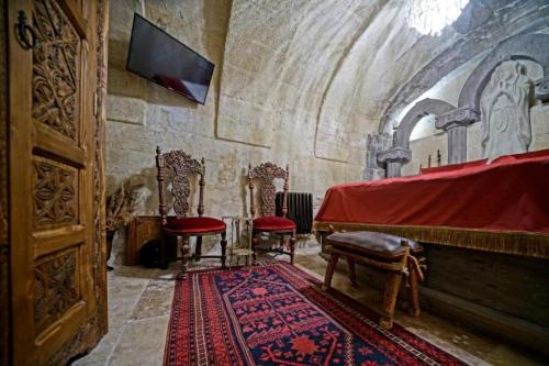 a room with two chairs and a altar in a church at Wish Cappadocia in Uchisar